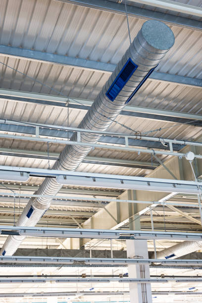 istock Ceiling mounted metal ventilation pipes inside industrial space. Low angle view, no people 2153057407