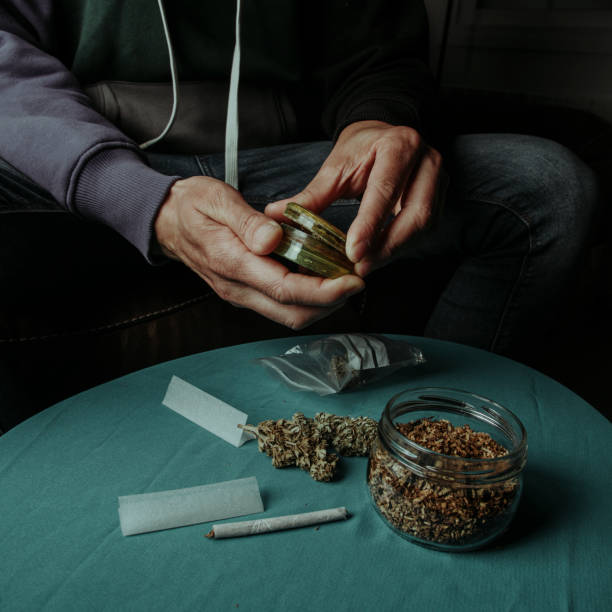 istock man about to shred a cannabis bud with a grinder 2153057978