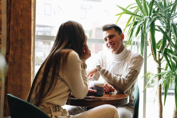 Man and Woman Sitting at Table Talking
