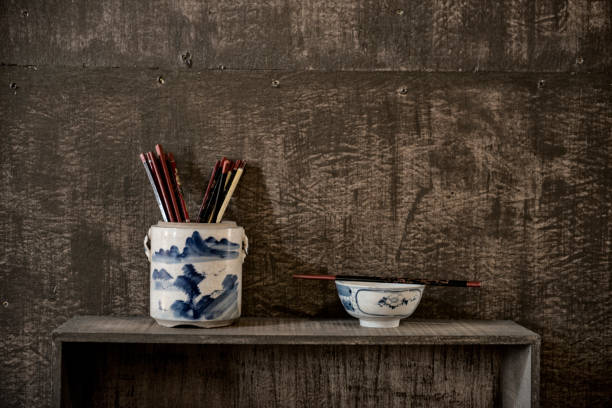 Hand Holding Chopsticks On White Background