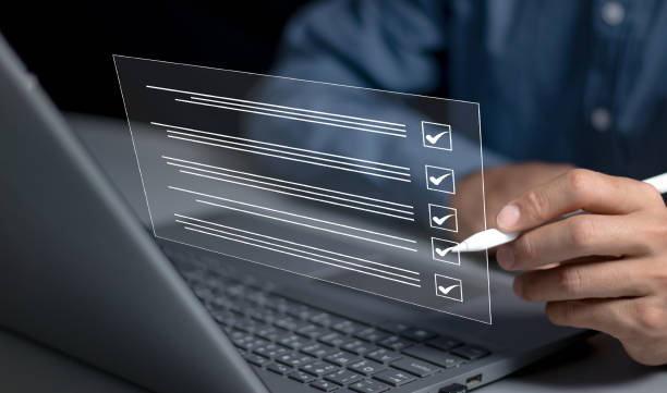 istock Businessman smart checklist and signs electronic on digital documents concept, Businessman use a pen signs on virtual screen documents with laptop on table 2153070769