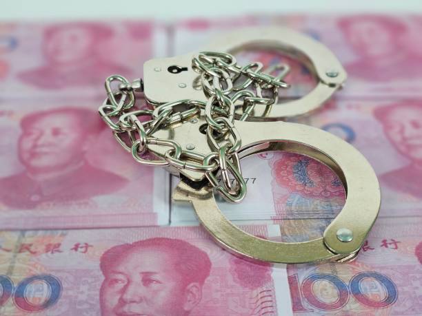 istock China flag with handcuffs and a bundle of dollars 2153071555