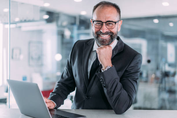 istock Successful businessman in modern office working on laptop. 2153071987
