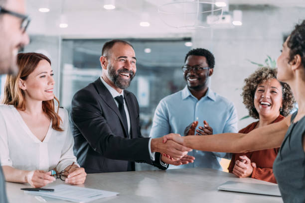 istock Businesspeople shaking hands across the table. 2153072000