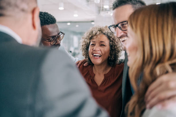 istock Excited coworkers embracing each other during a celebration in the office. 2153072004