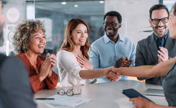 istock Businesspeople shaking hands across the table. 2153072008