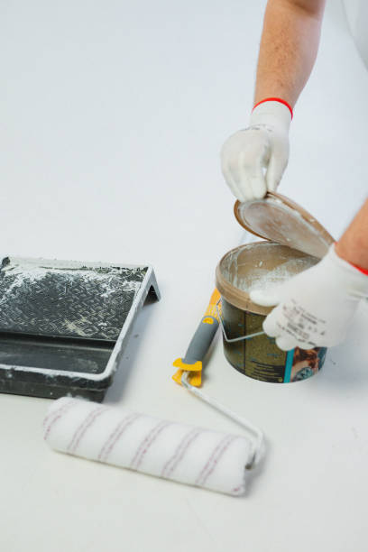 Construction tools close-up during repairs in a white empty room (brush, spatula, paint, drill, cement, putty, ruler). High quality photo
