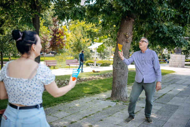 Father and daughter enjoying together outdoors on beautiful sunny day in city park