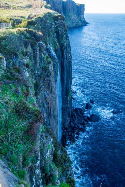 View on the waterfall and high rocky cliff from a view point, water of the North Sea down below