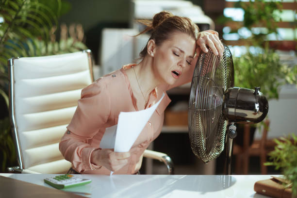 istock modern female employee at work suffering from summer heat 2153077692