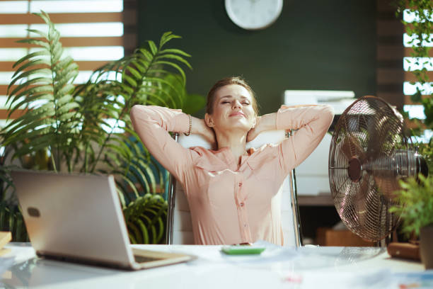 istock relaxed modern female employee in modern green office 2153077737