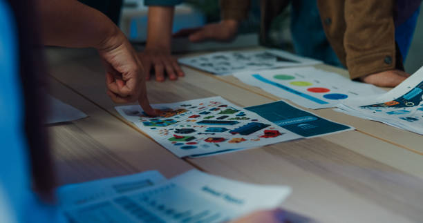 istock Close-up of team hands analyzing Environmental Social Governance (ESG) reports, reinforcing responsible business strategies in an office setting. ESG sustainable business office night. 2153078142