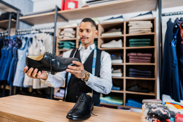 istock Salesman looking at shoes at the store 2153081180