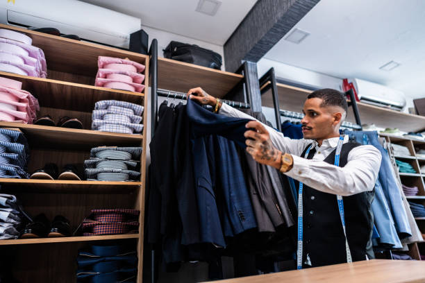 istock Tailor looking for suit at clothing store 2153081262