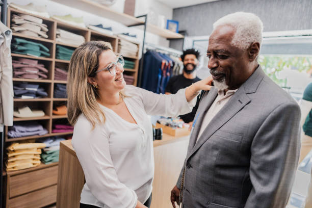 istock Tailor measuring a new suit for senior man at the store 2153081394
