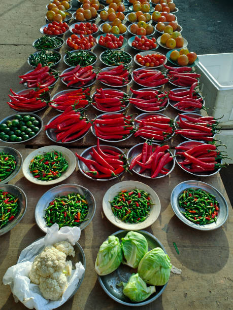Green and red hot chilli peppers at the market