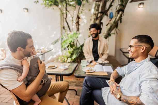 istock Father talking with friends while hold his daughter at coffee shop 2153082534