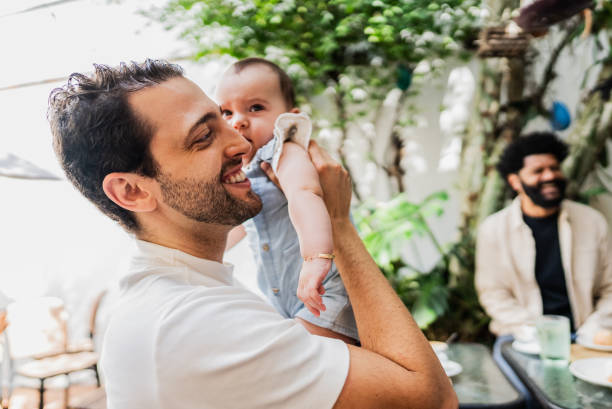 istock Father talking with friend while hold his daughter at coffee shop 2153083613