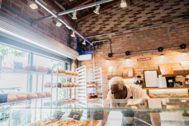 istock Senior baker man organizing food at bakery 2153083904