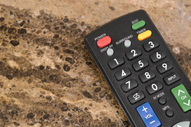 A close-up view of the TV remote reveals its sleek design and user-friendly interface, promising effortless control over your entertainment experience.