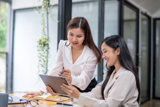 istock Two business worker consult and plan together. Brainstorm, share, and discuss business project ideas. 2153087370