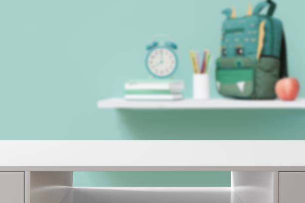 istock Empty white tabletop foreground with softly blurred background featuring school supplies, perfect for product displays and educational themes. Back to school, education concept. Desk front view. 3D. 2153087402