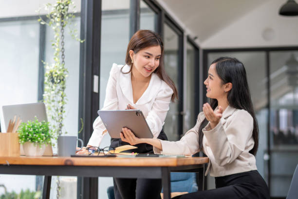 istock Two business worker consult and plan together. Brainstorm, share, and discuss business project ideas. 2153087565