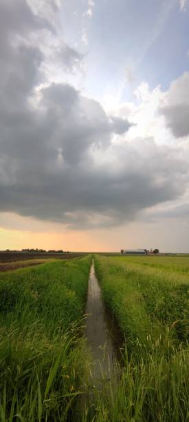 istock Beautiful rain cloud above a narrow ditch 2153089432