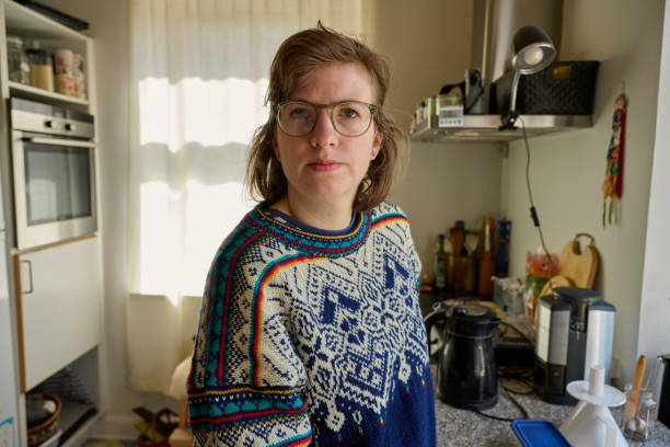 istock Woman wearing glasses standing in kitchen looking at camera 2153089892