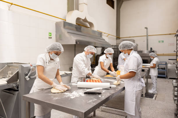 istock Group of bakers working at a donut factory 2153090597