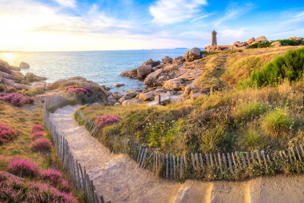Lighthouse of Ploumanach at the golden hour in Perros-Guirec, Cotes d'Armor, Brittany, France stock photo