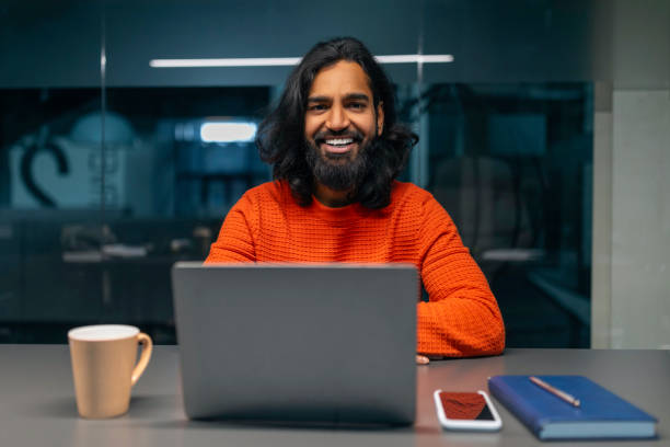 istock Smiling bearded man with laptop 2153093988