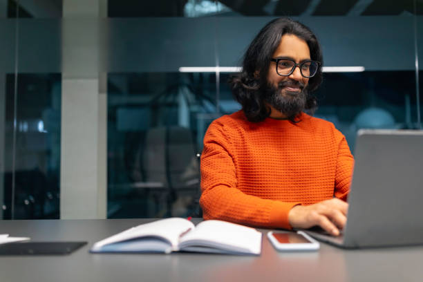Man working on laptop in modern office