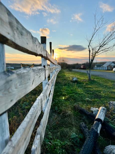 istock Fenced ranch at sunset, road to farm, Vertical photo 2153095584