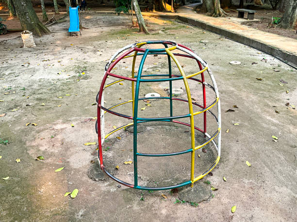 Colorful steel jungle gym equipment at public park playground. Climbing dome for kid.