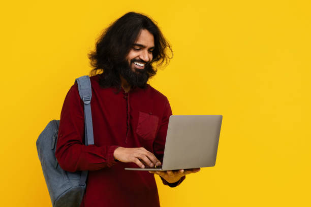 istock Man Student With Long Hair and Beard Using Laptop 2153096764