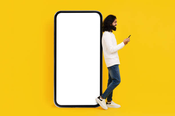istock Man in White Shirt Looking at Cell Phone 2153096783