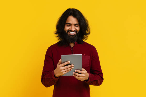 istock Man With Long Hair and Beard Holding Tablet 2153096805