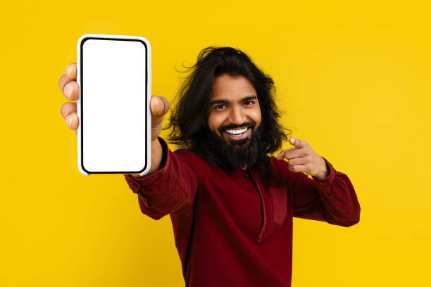 istock Cool indian man pointing at phone in his hand 2153096839