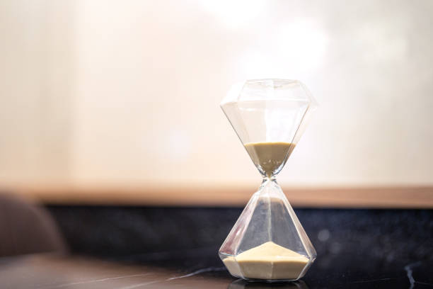 istock A sandglass or hourglass on table. 2153097115