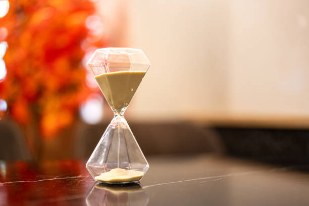 A sandglass or hourglass on table.