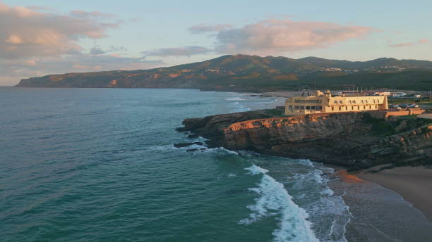 istock Aerial sunrise coastline awakening with warm morning light on cliffs beach. 2153097904