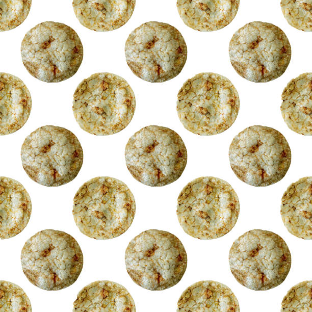 Brown rice chips with spices and salt isolated on white background as a seamless pattern