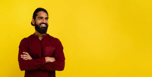 istock Confident indian guy looking at copy space on yellow 2153098565