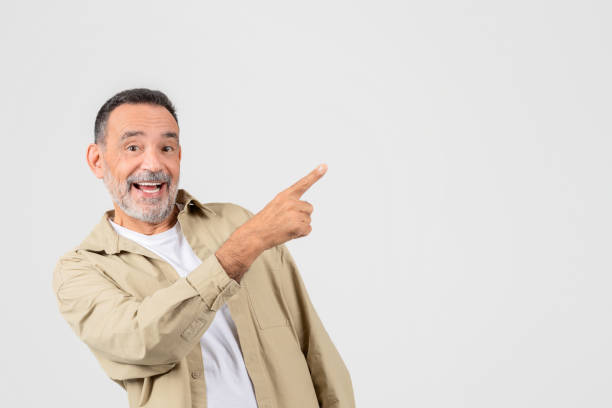 istock Smiling man pointing to the side, blank space 2153099110