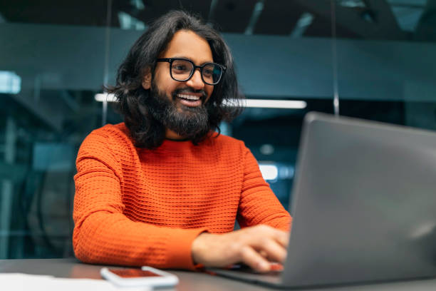istock Positive hard-working indian man IT professional working on laptop 2153100154