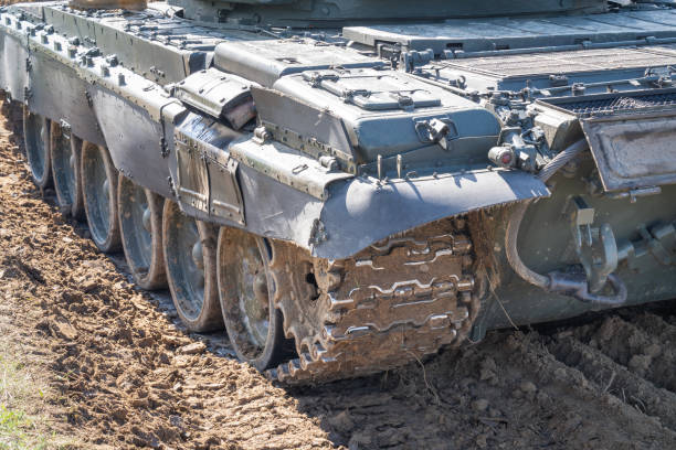 istock Camouflage tank with muddy tracks on the ground 2153103523