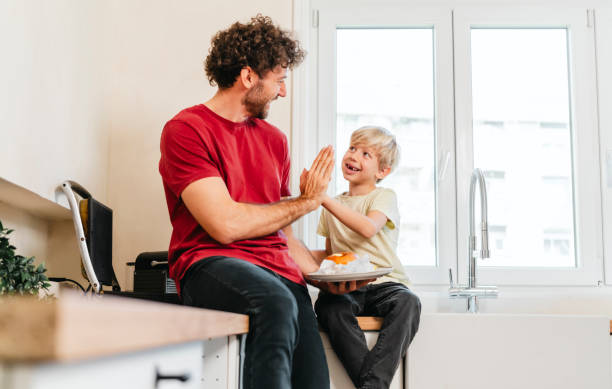 istock Father and son eating hamburger at home 2153111361
