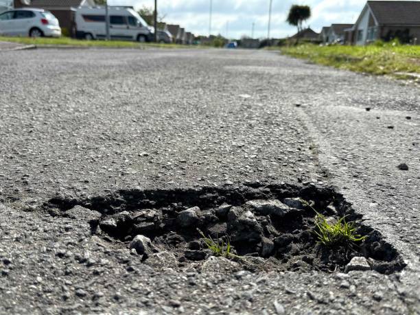 istock Pothole, residential street. 2153111666