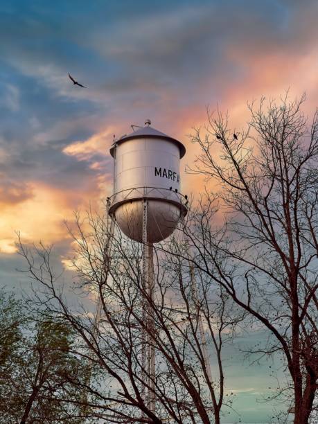 istock Marfa Texas water tower with raven circling above under dramatic skies 2153112579